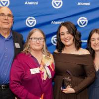 Gloria Masterton Hunter smiles with her award and supporters